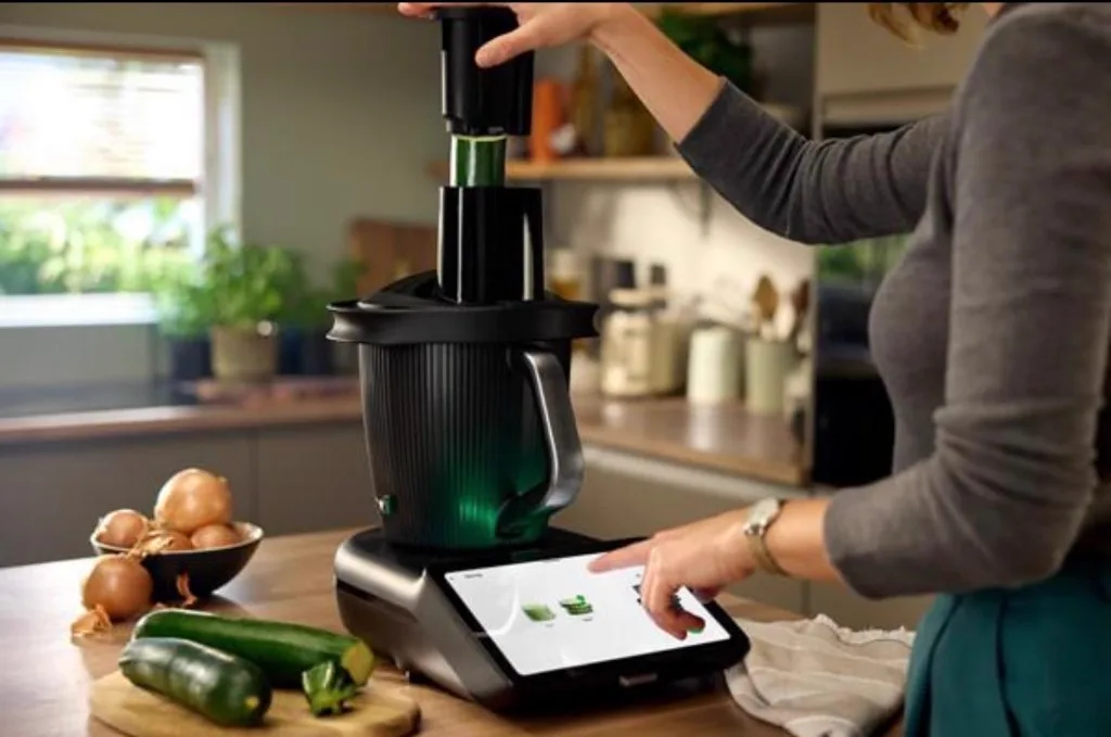 Vegetables being sliced with a Thermomix cutter attachment